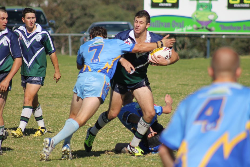 HARD HIT: Jason Cobon takes a tackle from his Wallangarra opponent. HARD HIT: Jason Cobon takes a tackle from his Wallangarra opponent.
